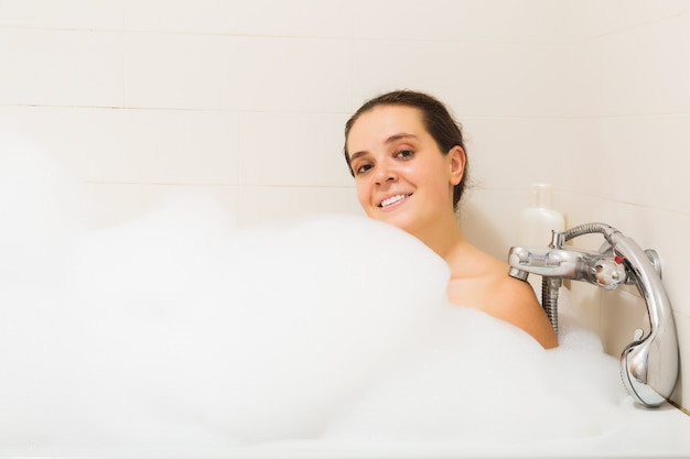 Free photo woman covered foam in bath