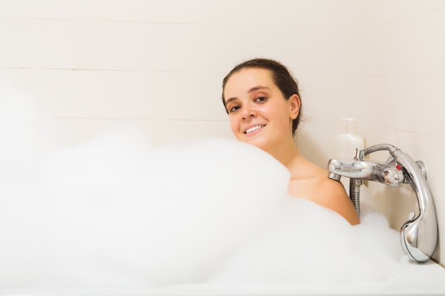   woman covered foam in bath