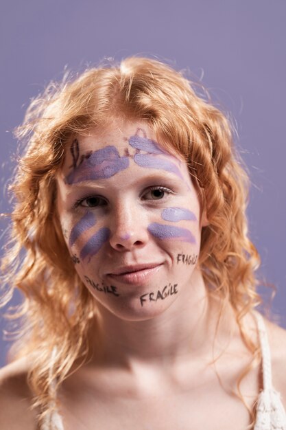 Woman covered with paint and  words as a sign of liberation