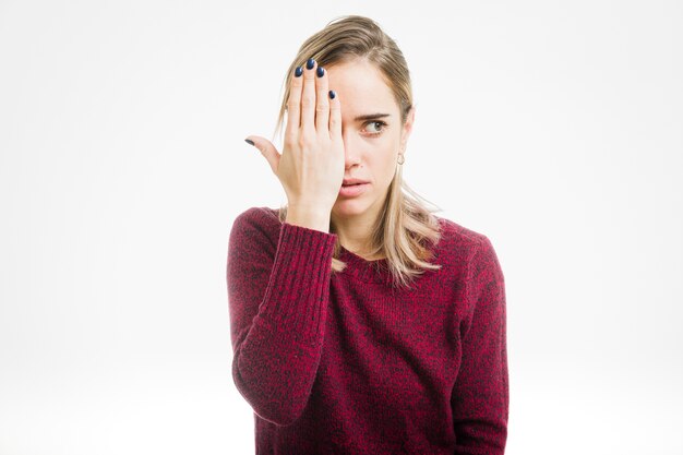 woman covering eye
