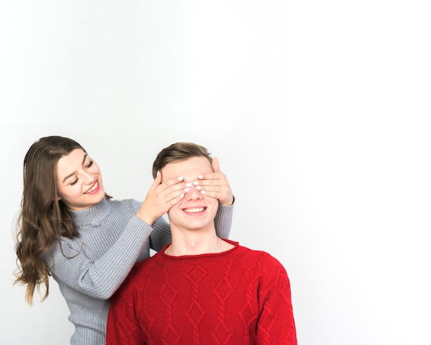 Free photo woman covering eyes of man with hands