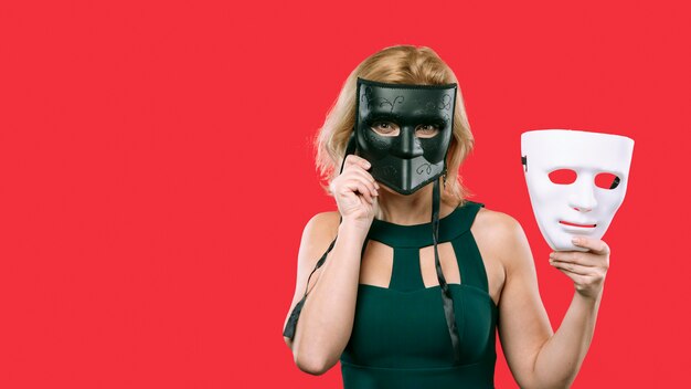 Woman covering face with black mask