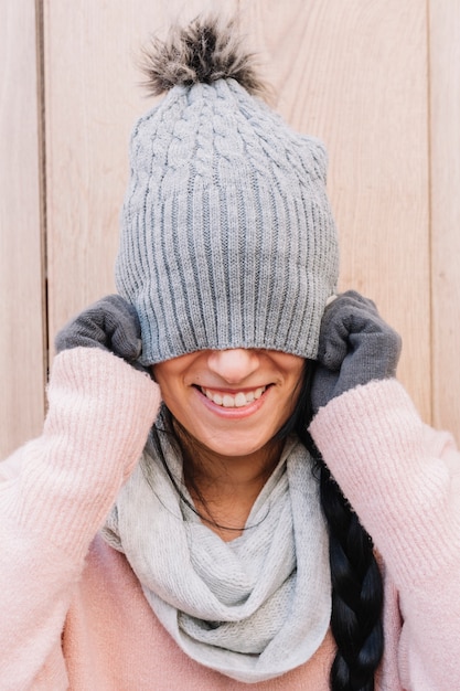 Free photo woman covering face with cap