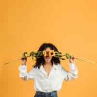 Free photo woman covering face with flowers