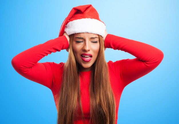 Woman covering her ears in a blue background