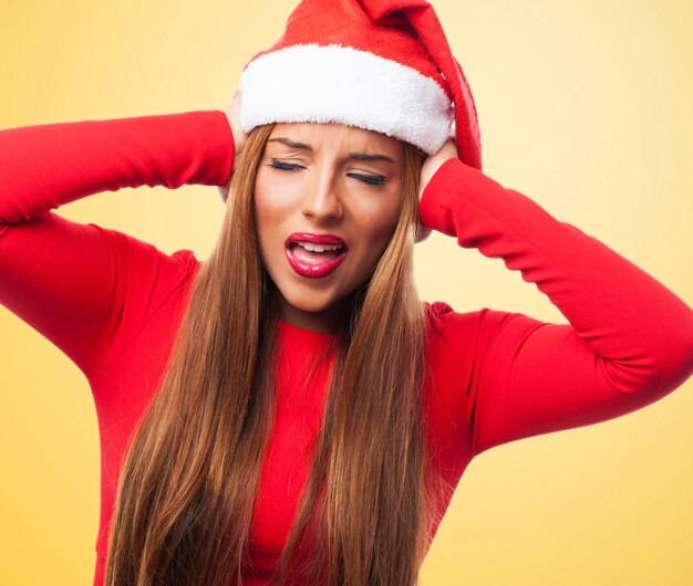 Woman covering her ears in a yellow background