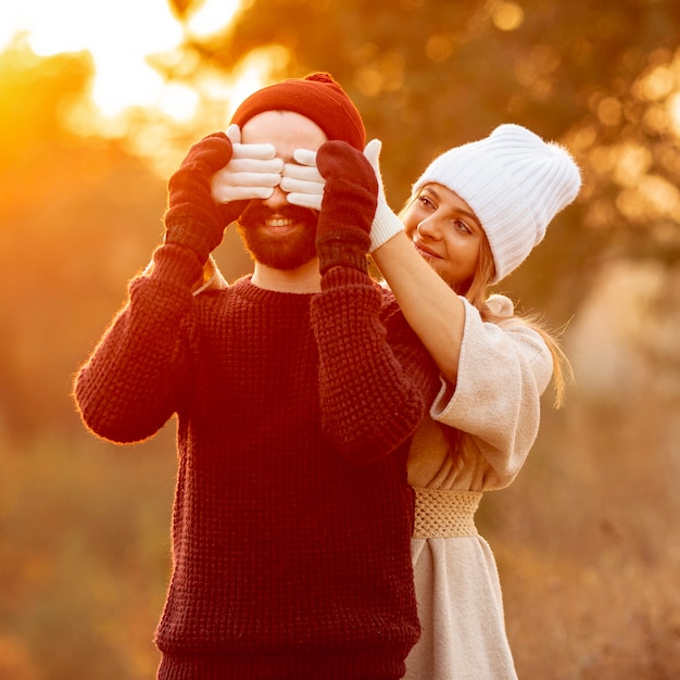 Free photo woman covering her friend's eyes