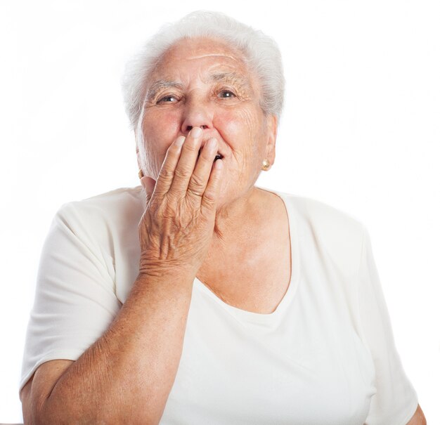 Woman covering her mouth while yawning