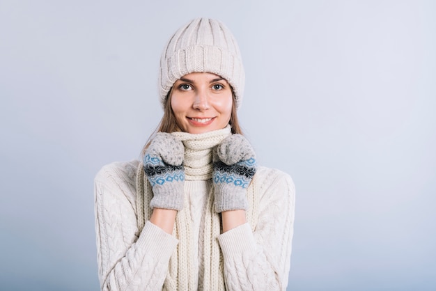 Woman covering neck with scarf 