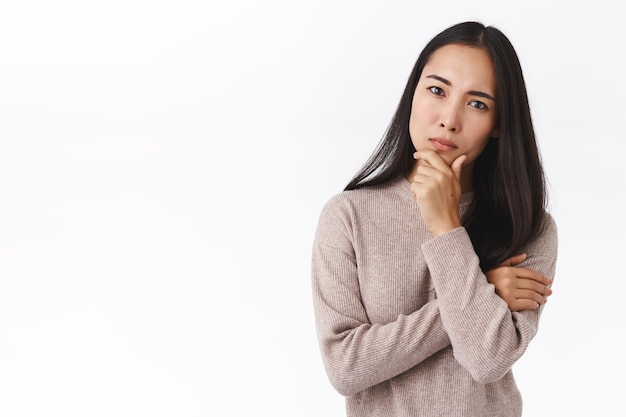 woman coworker, touching chin thoughtful, frowning as looking strict, concentrate on task