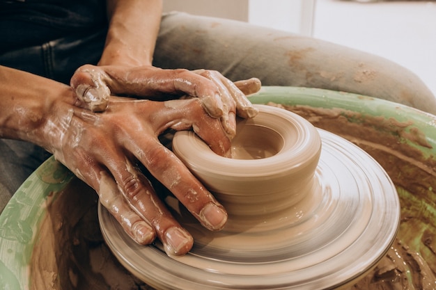 Free photo woman craftmaster at a pottery shop