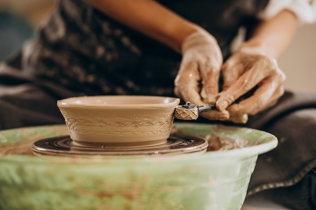 Free photo woman craftmaster at a pottery shop