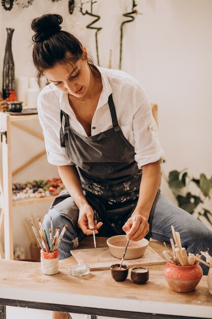 Woman craftmaster at a pottery shop