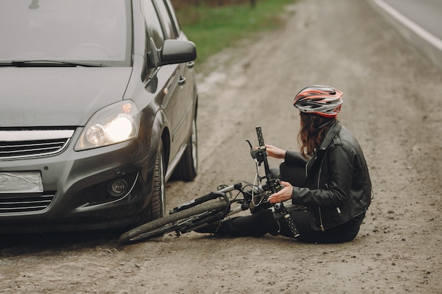 The woman crashed into the car. Girl in a helmet.