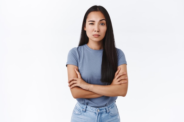 woman cross hands over chest in bossy, professional pose, stare judgemental and hesitant as measuring your ability cope with work