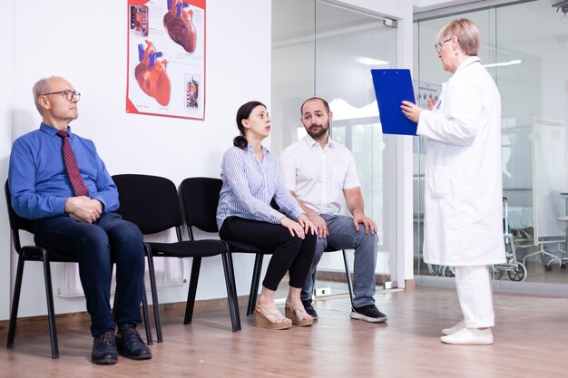 Woman crying looking at doctor after unfavorable news in hospital waiting area