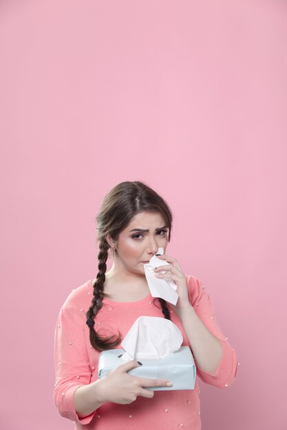 Woman crying and using box of napkins