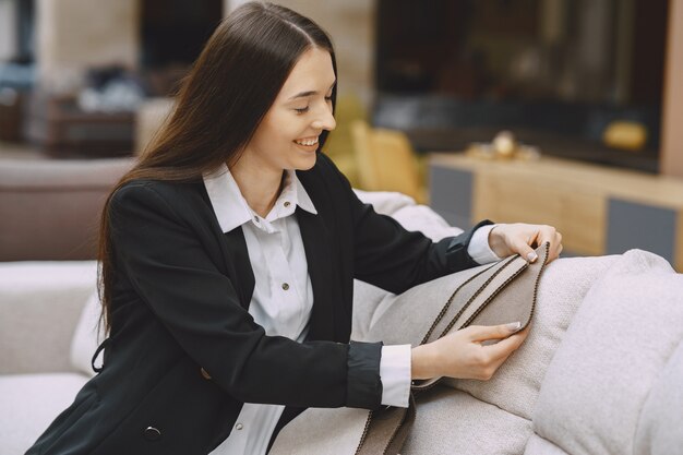 Woman customer looking for beautiful fabric in drapery shop