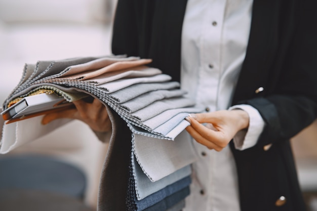 Woman customer looking for beautiful fabric in drapery shop