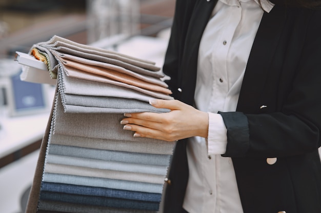 Woman customer looking for beautiful fabric in drapery shop