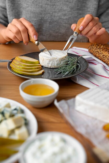 Woman cutting cheese front view