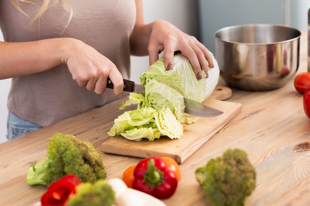 Woman cutting the iceberg cabbage