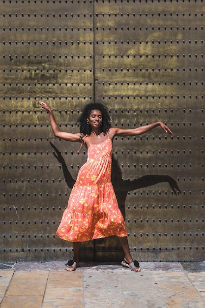 Free photo woman dancing on door of old building