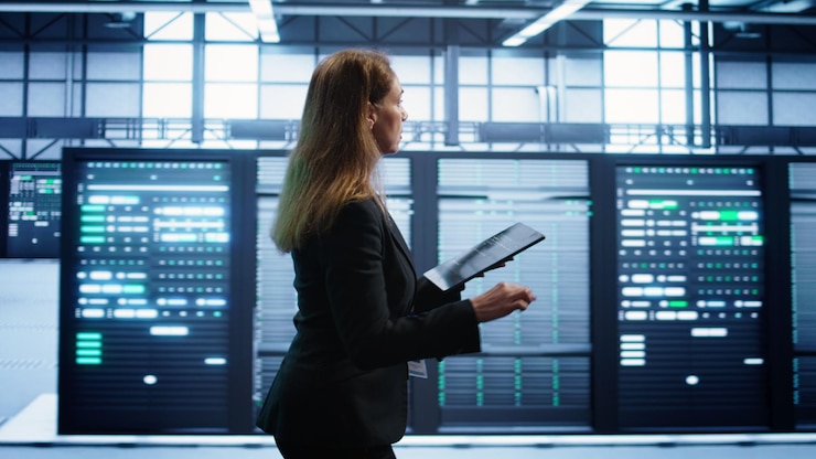 Free Photo woman in data center making sure rigs are functioning optimally