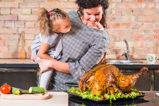 Woman and daughter looking at turkey