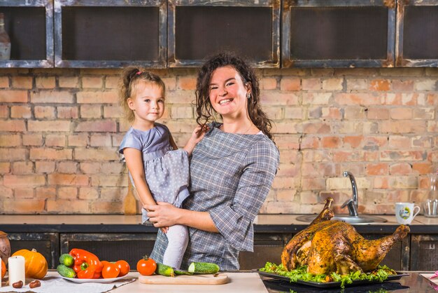 Woman and daughter at table with turkey