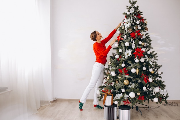 Woman decorating christmas tree