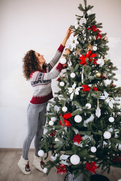 Woman decorating christmas tree