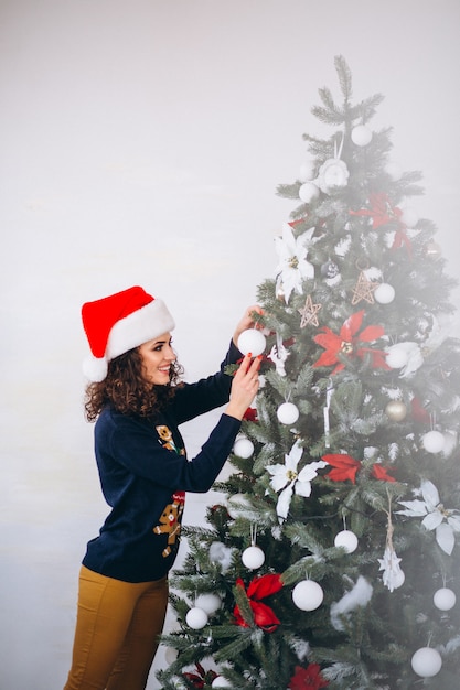 クリスマスツリーを飾る女性