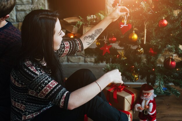 Woman decorating the christmas tree