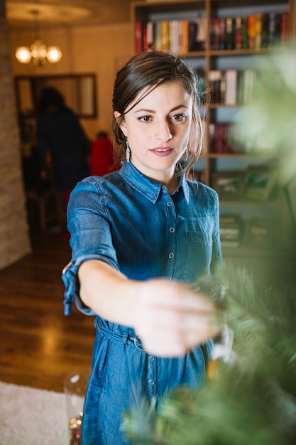 Woman decorating christmas tree