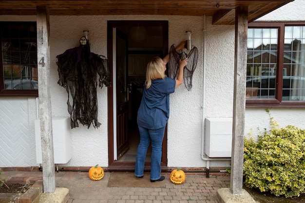 Woman decorating her home for halloween