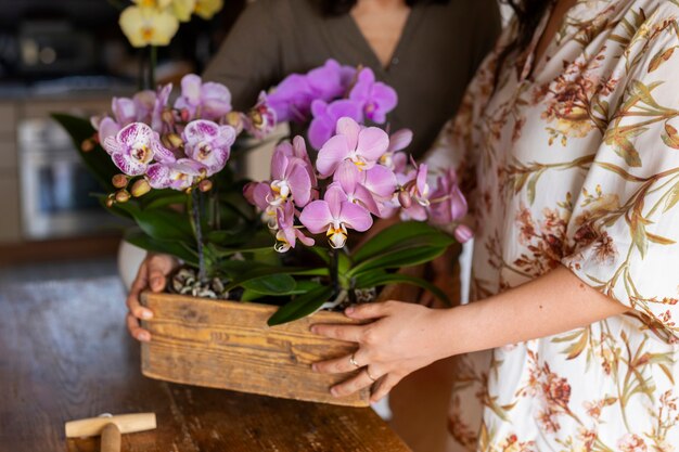 Woman decorating her house with orchids