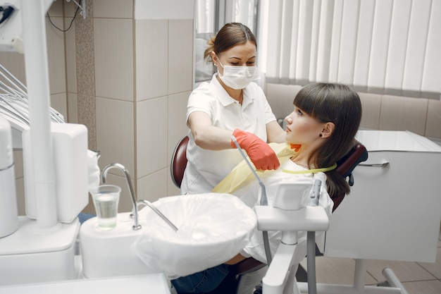 Woman in a dental chair. Girl is examined by a dentist.Beauty treats her teeth