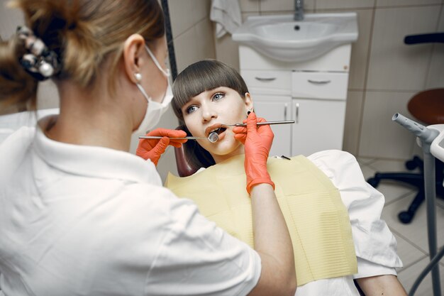 Woman in a dental chair. Girl is examined by a dentist.Beauty treats her teeth