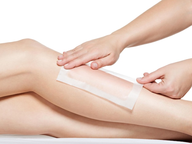 Free photo woman depilating her legs by waxing