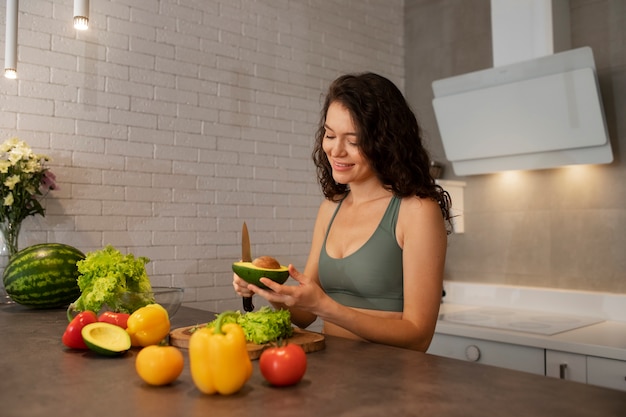 Woman digital disconnecting at home by making a healthy vegetable salad