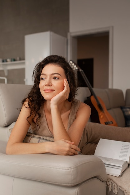 Woman digital disconnecting at home by reading book