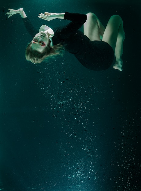 Woman diving in a water tank