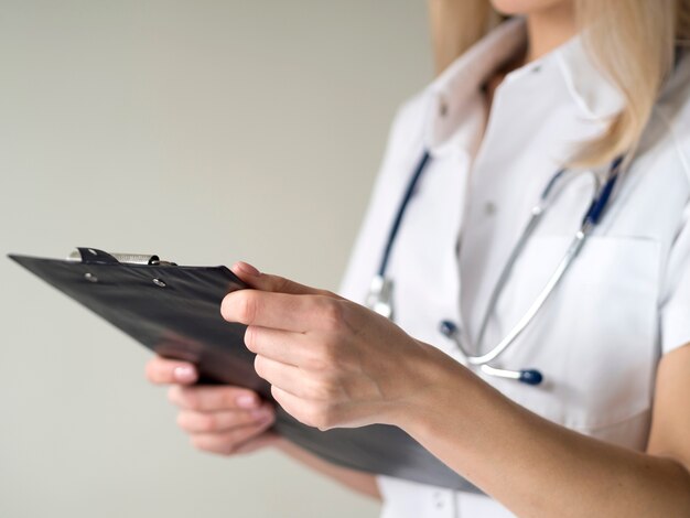 Woman doctor holding clipboard