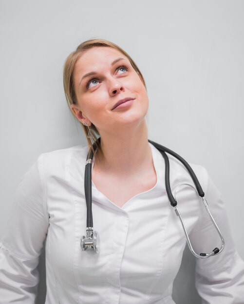 Woman doctor looking up