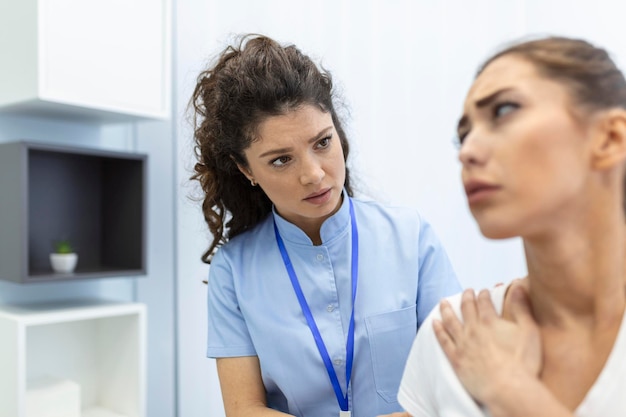 Woman doctor osteopath in medical uniform fixing woman patients shoulder and back joints in manual therapy clinic during visit Professional osteopath during work with patient concept