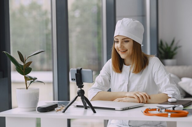 Woman doctor recording vlog video about medicin