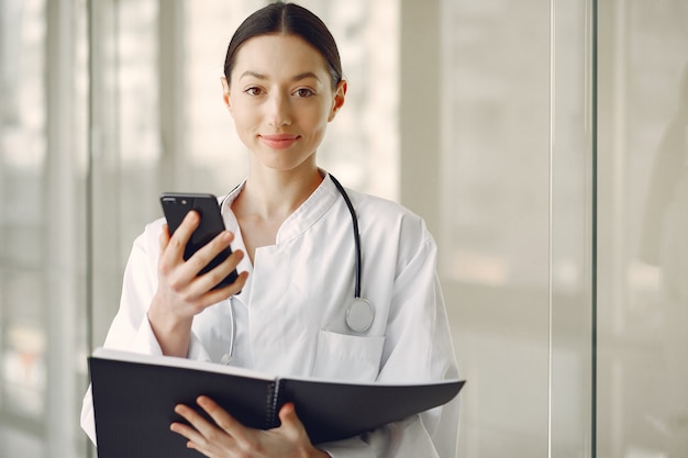 Woman doctor in a white uniform standing in a hall