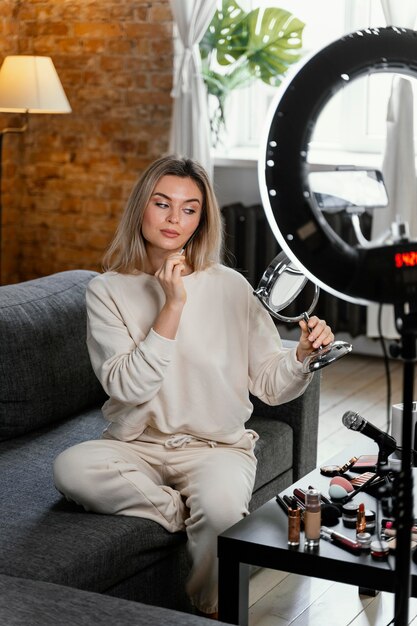 Woman doing a beauty vlog at home