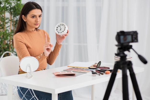 Woman doing a commercial with a clock